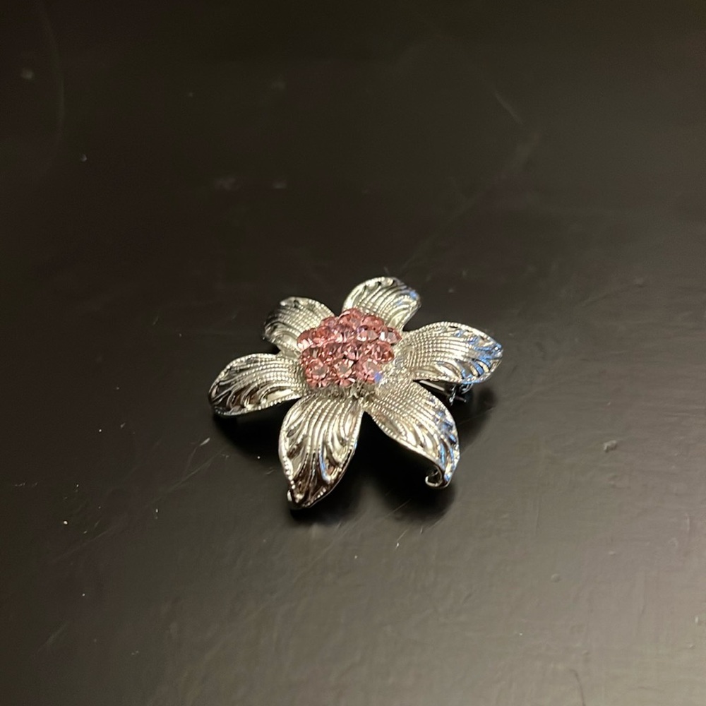Silver flower pin with pink stone center